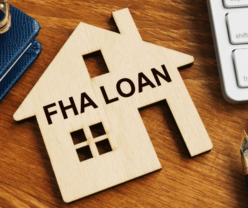 FHA mortgage loan wood cutout next to a keyboard
